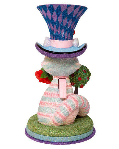Christmas Cheer All Year Colorful Cheshire cat Alice in Wonderland figurine with a harlequin hat, stop watch, roses, and striped boots on a white background