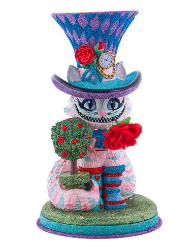 Christmas Cheer All Year Colorful Cheshire cat Alice in Wonderland figurine with a harlequin hat, stop watch, roses, and striped boots on a white background