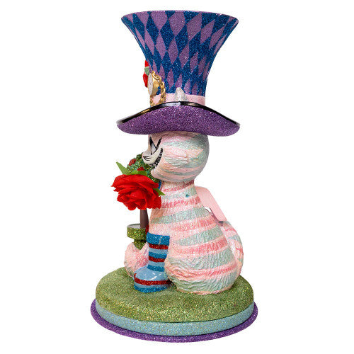 Christmas Cheer All Year Colorful Cheshire cat Alice in Wonderland figurine with a harlequin hat, stop watch, roses, and striped boots on a white background