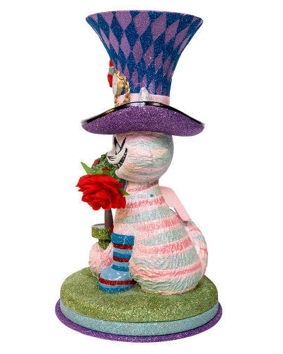 Christmas Cheer All Year Colorful Cheshire cat Alice in Wonderland figurine with a harlequin hat, stop watch, roses, and striped boots on a white background