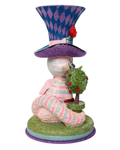 Christmas Cheer All Year Colorful Cheshire cat Alice in Wonderland figurine with a harlequin hat, stop watch, roses, and striped boots on a white background
