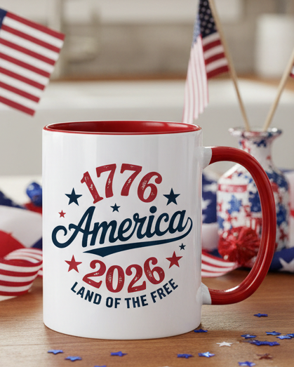Christmas Cheer All Year 250th Anniversary patriotic mug featuring '1776 America 2026' text and American flags in a kitchen.