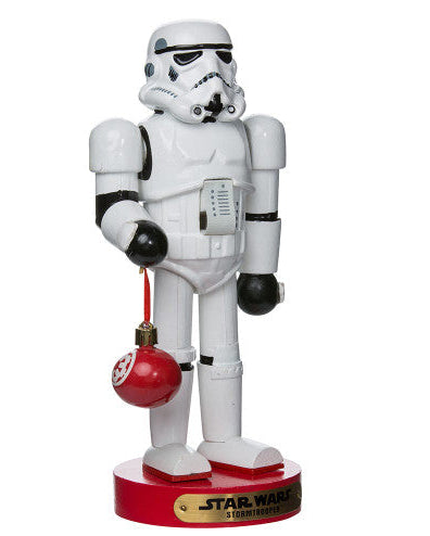 Christmas Cheer All Year Officially Licensed Star Wars Stormtrooper Nutcracker with a Christmas ornament by Kurt Adler in front of a decorated tree