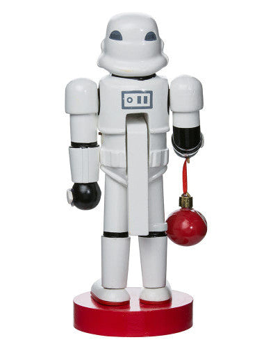 Christmas Cheer All Year Officially Licensed Star Wars Stormtrooper Nutcracker with a Christmas ornament by Kurt Adler in front of a decorated tree