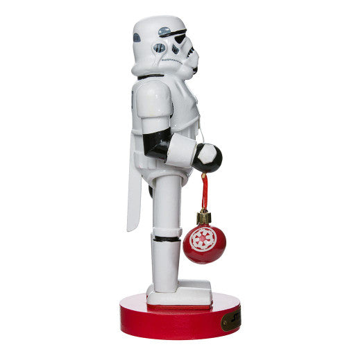 Christmas Cheer All Year Officially Licensed Star Wars Stormtrooper Nutcracker with a Christmas ornament by Kurt Adler in front of a decorated tree