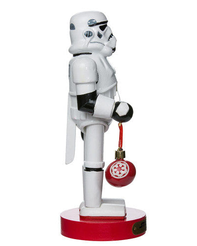 Christmas Cheer All Year Officially Licensed Star Wars Stormtrooper Nutcracker with a Christmas ornament by Kurt Adler in front of a decorated tree