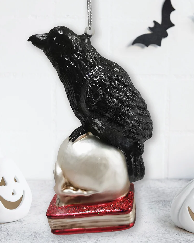 The Canton Christmas Shop Black Raven Perched on Skull on Glittered Book Ornament