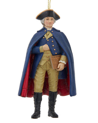 Christmas Cheer All Year 250th USA birthday George Washington Ornament in colonial attire with a blue coat and red interior, holding the U.S. constitution