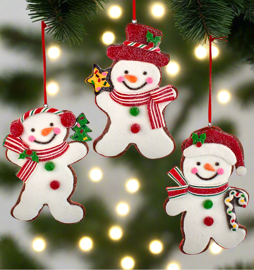 Three snowman-shaped Christmas ornaments hanging on a tree Christmas Cheer All Year