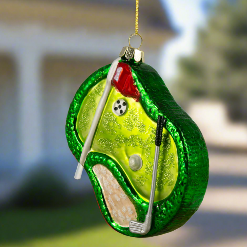 The Canton Christmas Shop Golf Course Hole in One Ornament in front of a country club