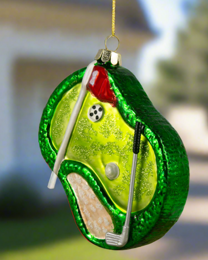 Christmas Cheer All Year Golf Course Hole in One Ornament in front of a country club