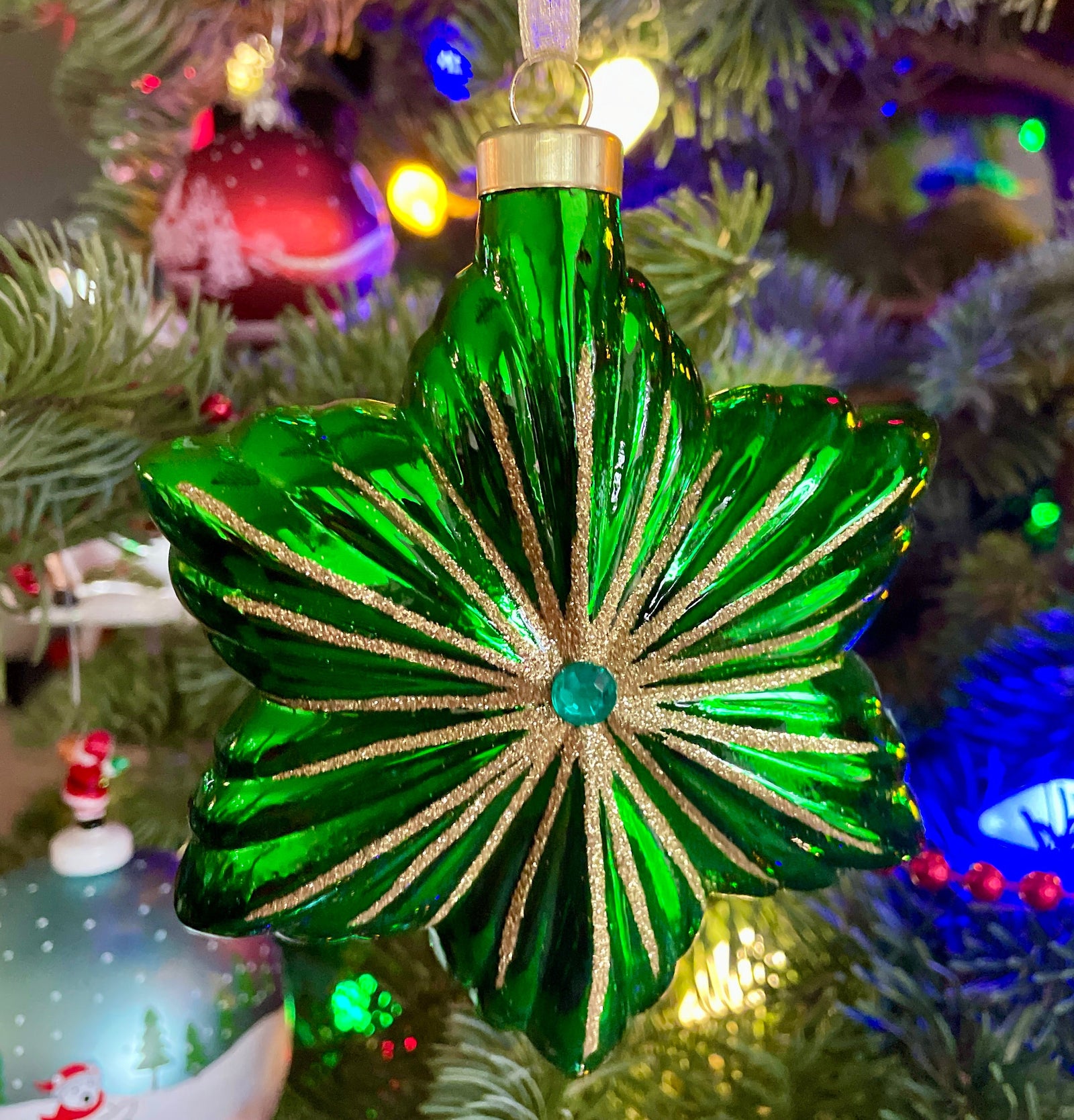 Christmas Cheer All Year Green glass ornament with gold accents on a decorated Christmas tree.
