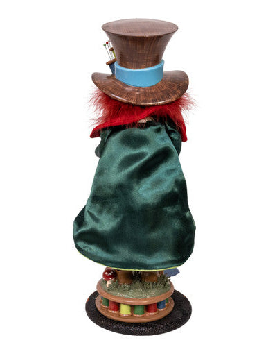 Figurine of a character with a top hat and green robe on a white background