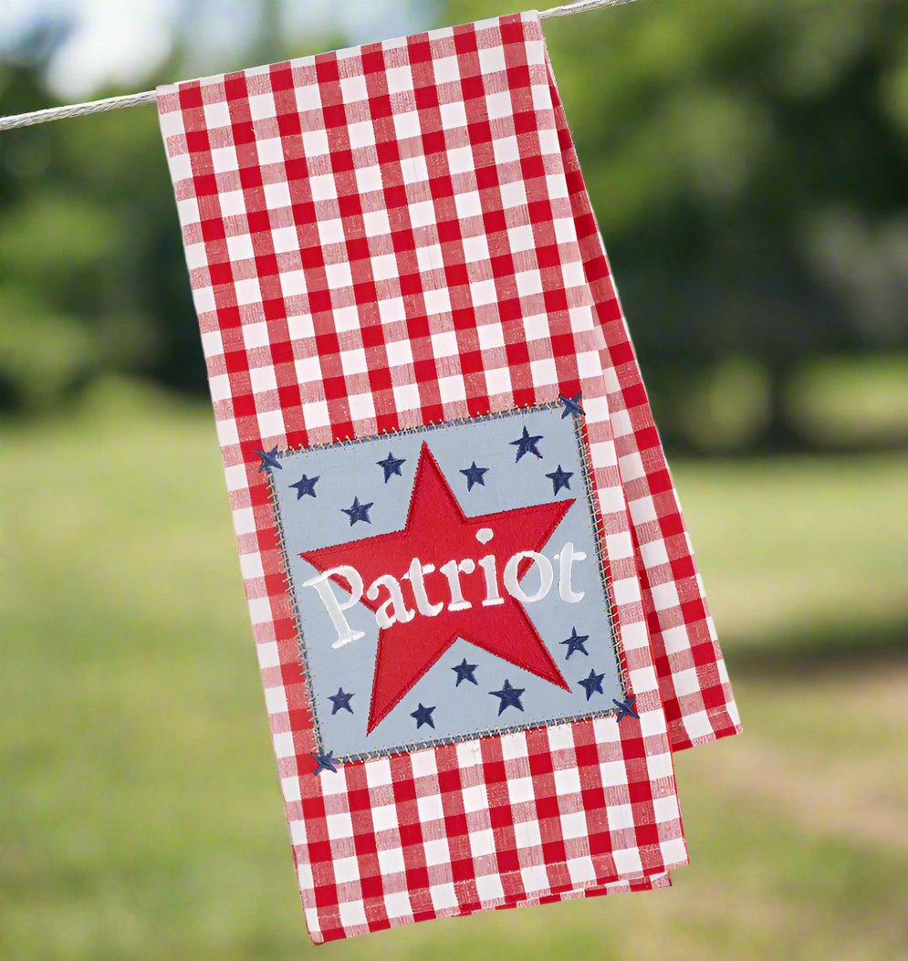 The Canton Christmas Shop Patriot Star Embellished Kitchen Towel hanging outside