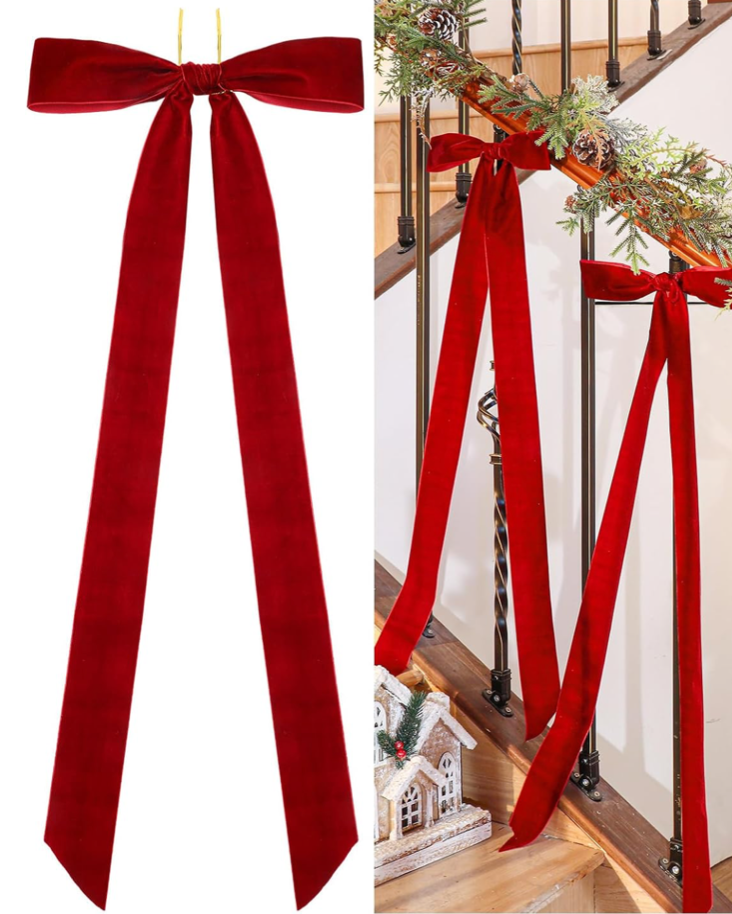 Red velvet ribbon tied into a bow on a white background, with another bow draped over a staircase railing.