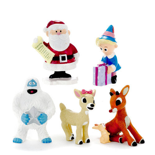 Christmas Cheer All Year holiday scene with Santa Claus, Rudolph, Clarice, Hermey, Bumble, and other characters in a snowy landscape with decorated trees.