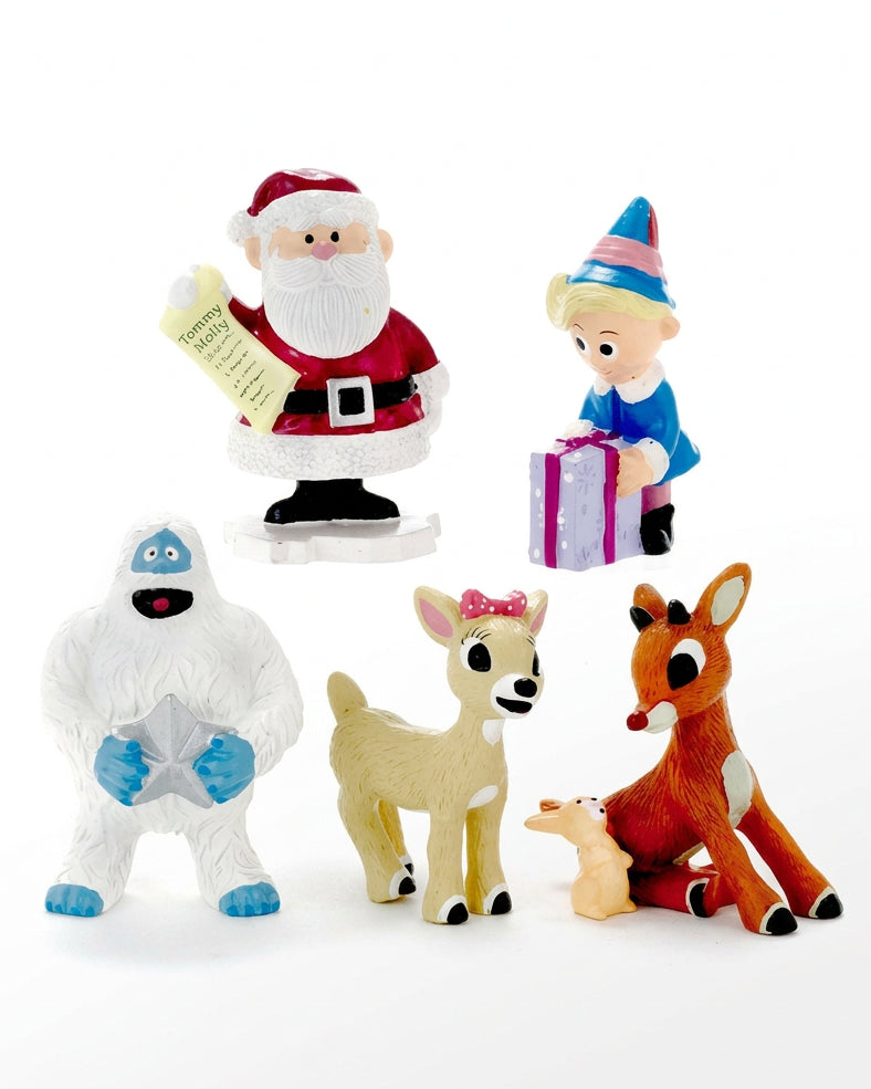 Christmas Cheer All Year holiday scene with Santa Claus, Rudolph, Clarice, Hermey, Bumble, and other characters in a snowy landscape with decorated trees.