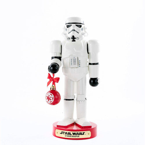 Christmas Cheer All Year Officially Licensed Star Wars Stormtrooper Nutcracker with a Christmas ornament by Kurt Adler in front of a decorated tree