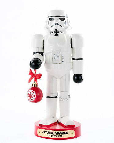 Christmas Cheer All Year Officially Licensed Star Wars Stormtrooper Nutcracker with a Christmas ornament by Kurt Adler in front of a decorated tree
