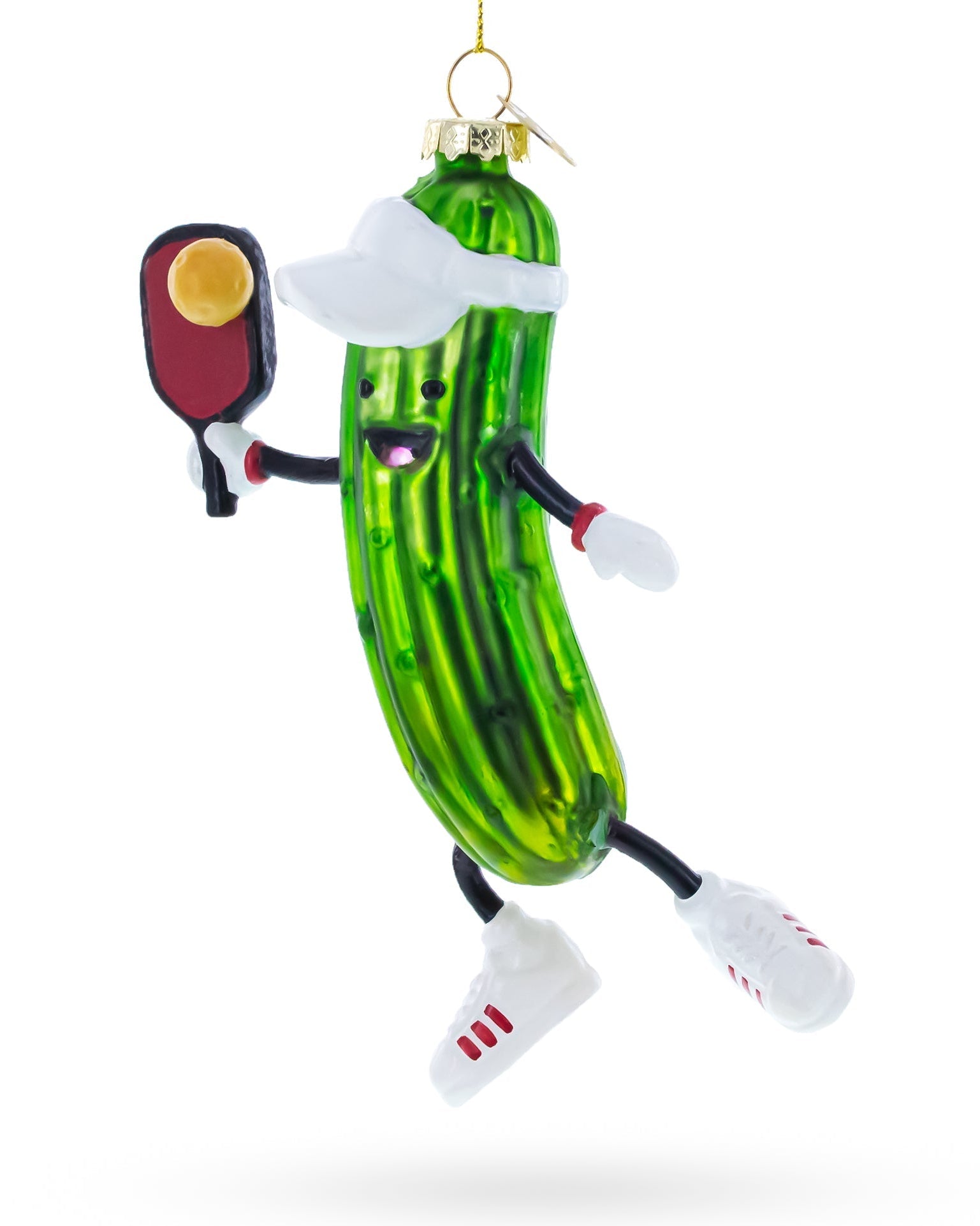 Christmas pickle ornament with arms, legs, and a face holding a paddle on a white background