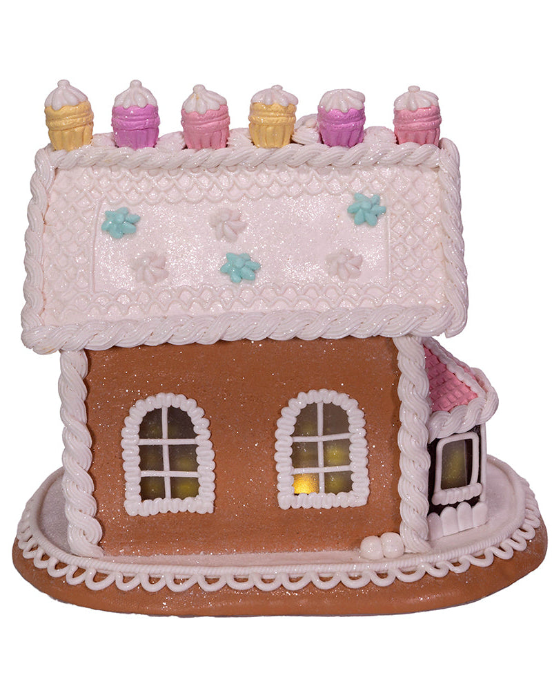 Decorative gingerbread house with icing details on a white background