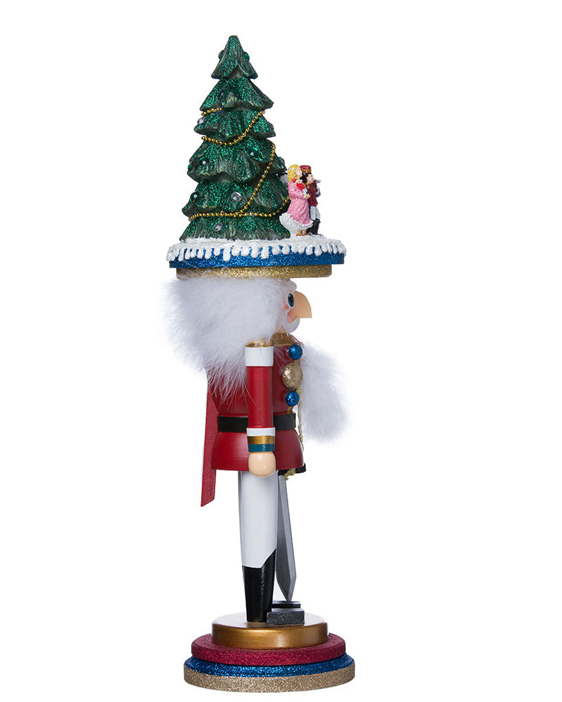 Decorative nutcracker with a Christmas tree and figures on a white background