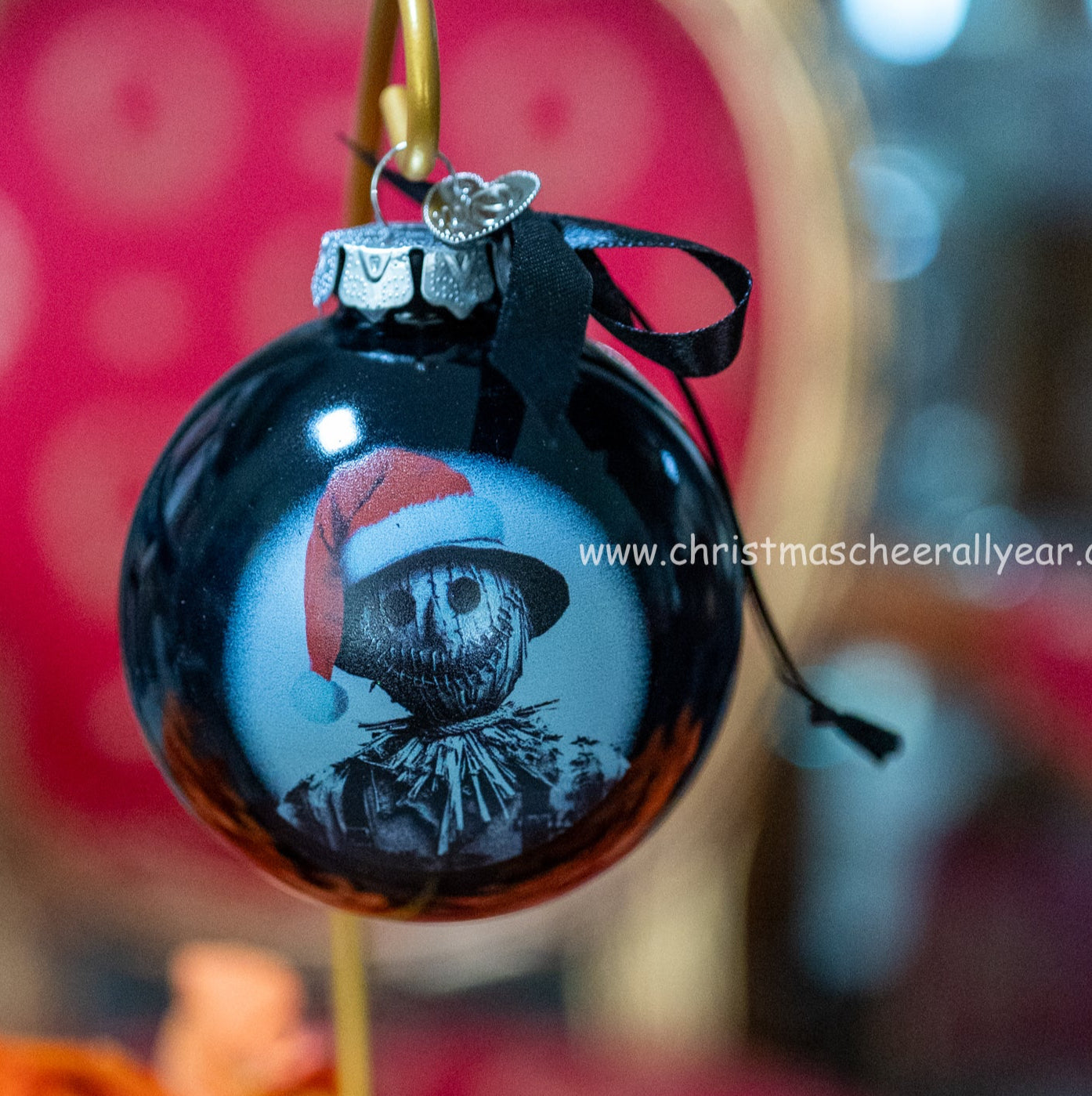 Black Christmas ornament with a scarecrow wearing a Santa hat on a blurred background Christmas Cheer All year