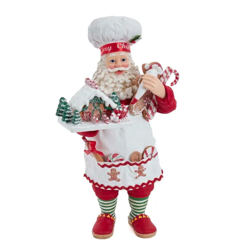 The Canton Christmas Shop 10.5" Fabriché™ Gingerbread Chef Santa with Gingerbread House and Piping Bag