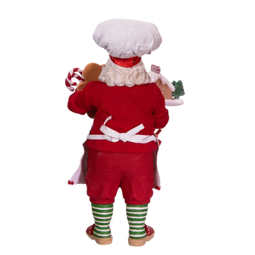 The Canton Christmas Shop 10.5" Fabriché™ Gingerbread Chef Santa with Gingerbread House and Piping Bag