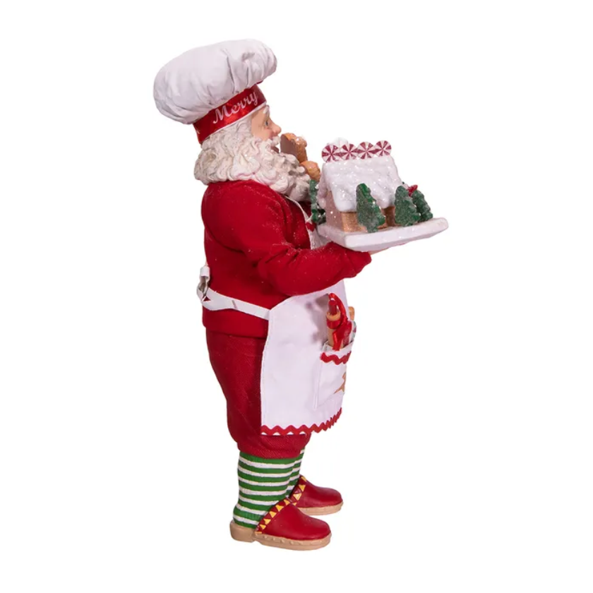 The Canton Christmas Shop 10.5" Fabriché™ Gingerbread Chef Santa with Gingerbread House and Piping Bag