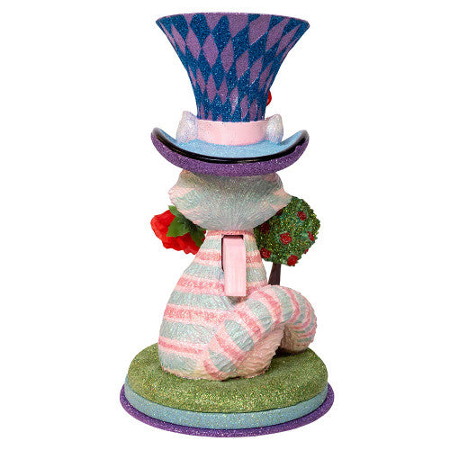 Christmas Cheer All Year Colorful Cheshire cat Alice in Wonderland figurine with a harlequin hat, stop watch, roses, and striped boots on a white background
