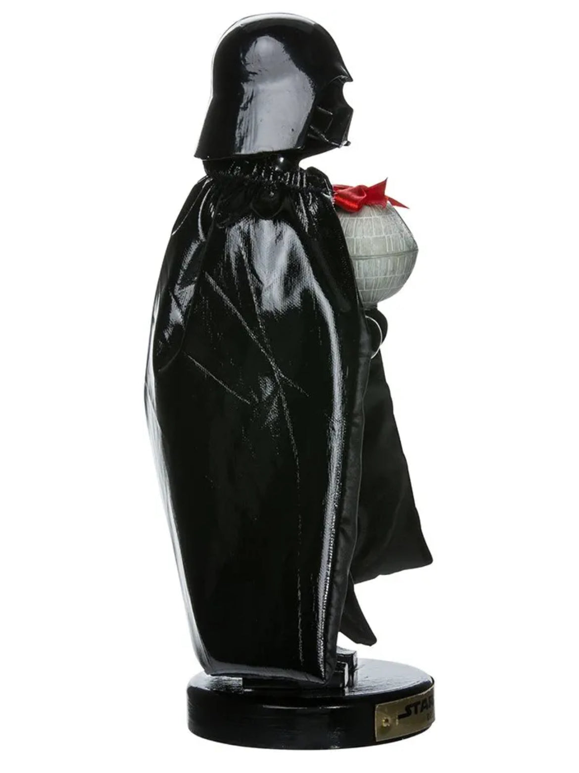 Christmas Cheer All Year A 10-inch tall Star Wars Darth Vader nutcracker figurine, featuring the character in his iconic black helmet and cape, holding a Death Star wrapped in a bow, standing on a base with a Star Wars logo from Kurt Adler