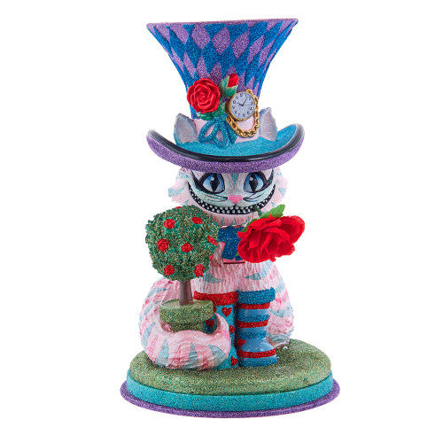 Christmas Cheer All Year Colorful Cheshire cat Alice in Wonderland figurine with a harlequin hat, stop watch, roses, and striped boots on a white background