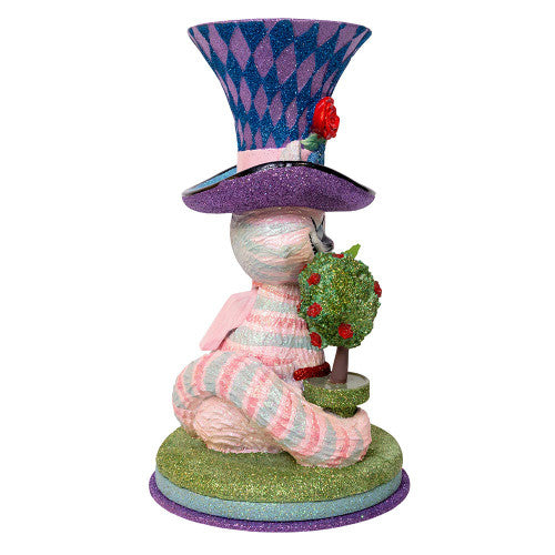 Christmas Cheer All Year Colorful Cheshire cat Alice in Wonderland figurine with a harlequin hat, stop watch, roses, and striped boots on a white background