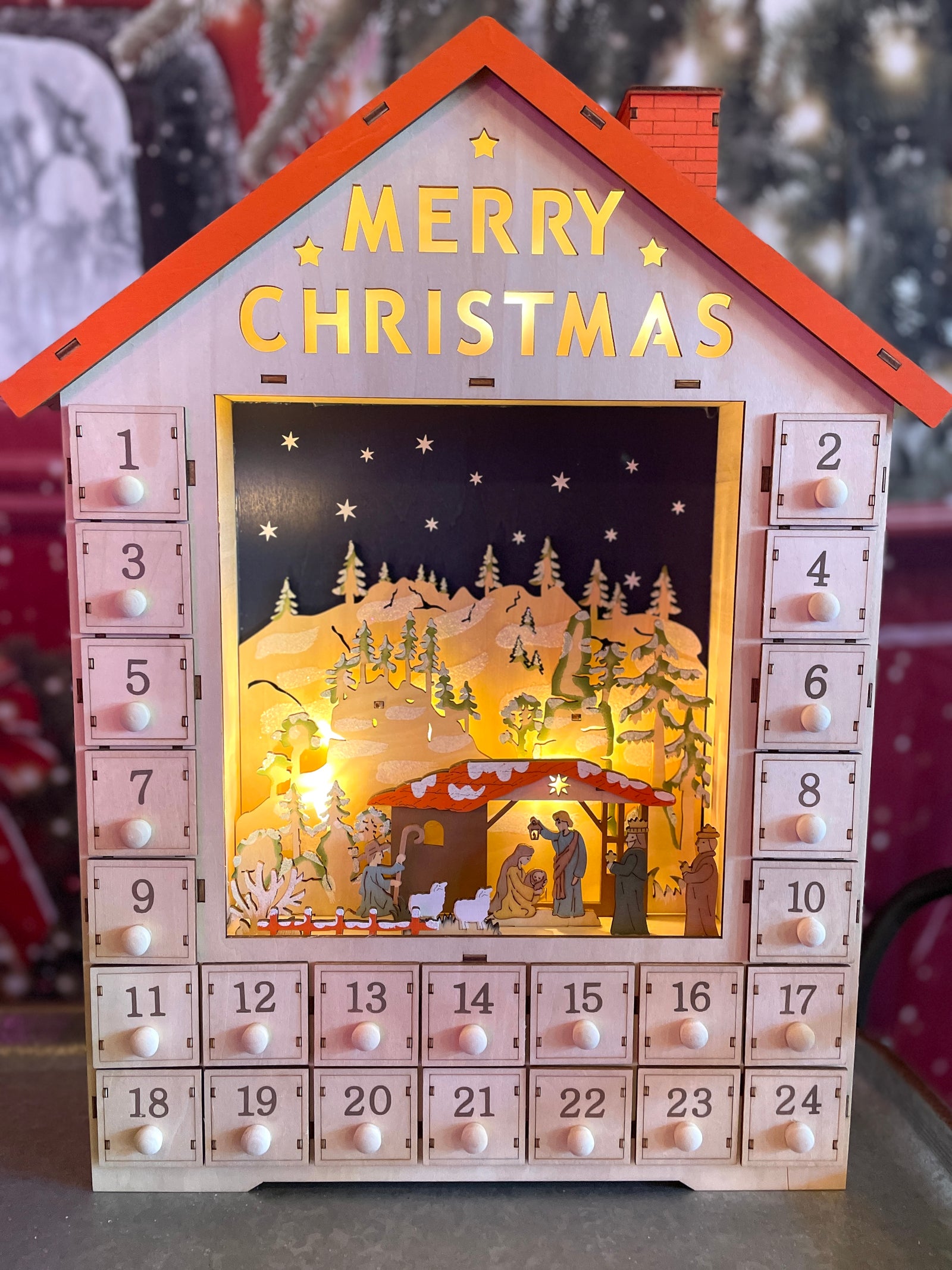 19" Lit Advent Calendar House with Nativity and Orange Roof by Kurt Adler straight on view on white background
