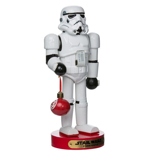 Christmas Cheer All Year Officially Licensed Star Wars Stormtrooper Nutcracker with a Christmas ornament by Kurt Adler in front of a decorated tree