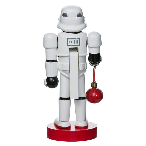Christmas Cheer All Year Officially Licensed Star Wars Stormtrooper Nutcracker with a Christmas ornament by Kurt Adler in front of a decorated tree