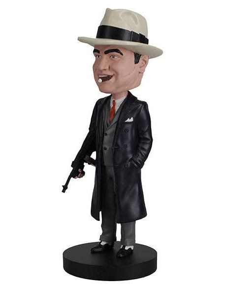 Christmas Cheer All Year American Gangster Bobblehead figure in formal attire with cigar in mouth banded hat trench coat suit and tie and tommy gun standing on a black base that says Al Capone