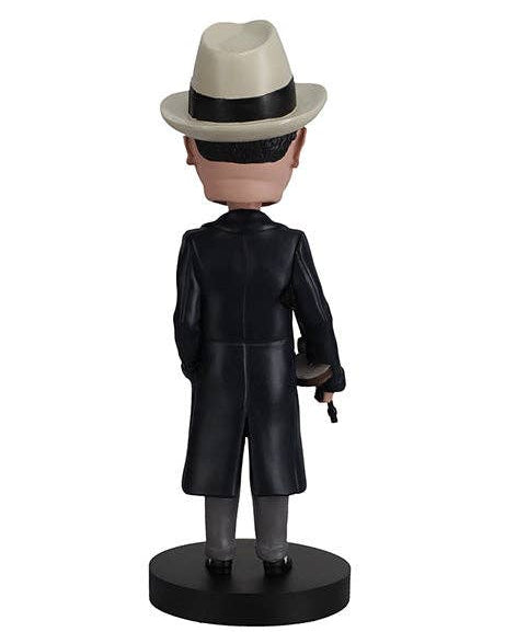 Christmas Cheer All Year American Gangster Bobblehead figure from the back in formal attire beige fedora hat trench coat suit and tie and tommy gun standing on a black base 