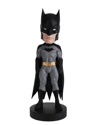 christmas cheer all year A stylized Batman bobblehead figure with a black cowl and cape, gray suit, and gold utility belt, standing on a round black base against a plain white background.