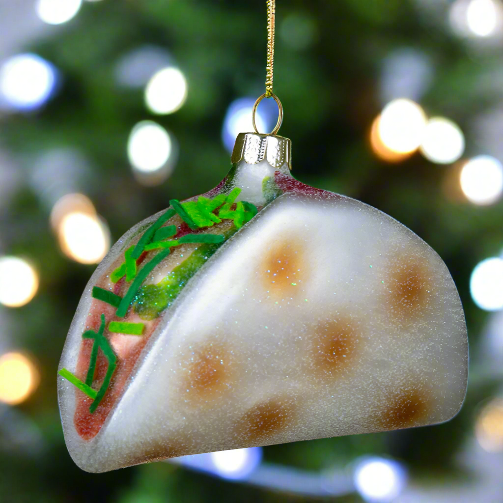 The Canton Christmas Shop Big Taco Glass Ornament hanging on a Christmas tree in a mexican restaurant 