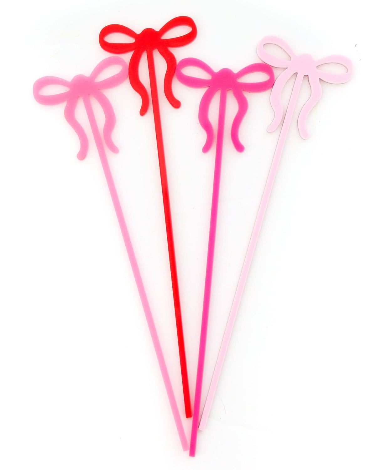 Four acrylic cocktail stirrers with bow-shaped tops in red, pink, and light pink, arranged vertically on a white background.