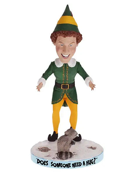 Christmas Cheer All Year Scene from Elf the Movie Bobblehead figure of Buddy the Elf in green and yellow elf costume and hat with a raccoon on base that says "does someone need a hug?"