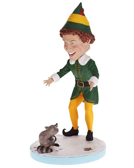 Christmas Cheer All Year Scene from Elf the Movie Bobblehead figure of Buddy the Elf in green and yellow elf costume and hat with a raccoon on base that says "does someone need a hug?"