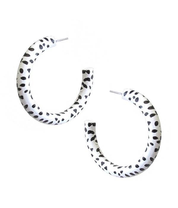 Dalmatian Print Pair of hoop earrings with black dot pattern on a white background