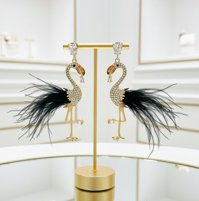 Amanda Bright Designs Feathered flamingo statement earrings on a gold stand against a white background