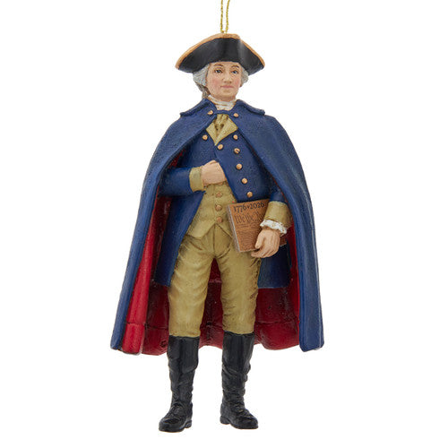 Christmas Cheer All Year 250th USA birthday George Washington Ornament in colonial attire with a blue coat and red interior, holding the U.S. constitution