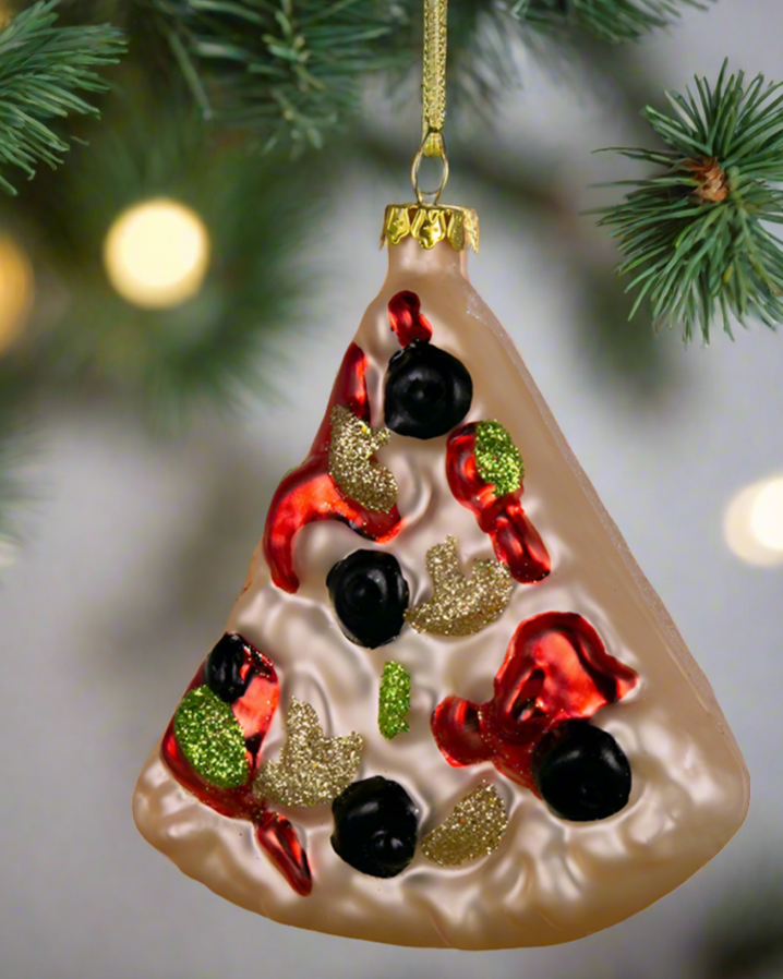 Christmas Cheer All Year glass ornament designed to resemble a slice of pizza with red and green toppings and a golden brown crust, hanging from a Christmas tree.
