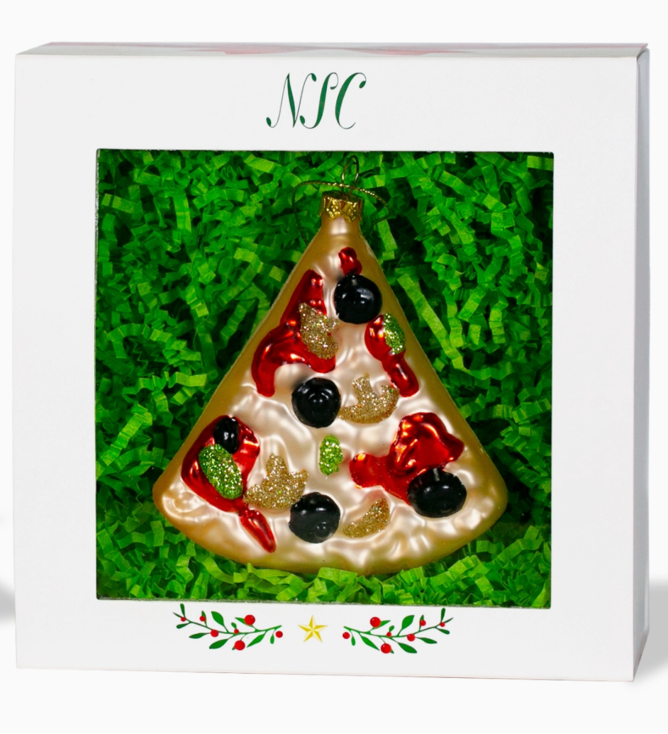 Christmas Cheer All Year glass ornament designed to resemble a slice of pizza with red and green toppings and a golden brown crust, hanging from a Christmas tree.