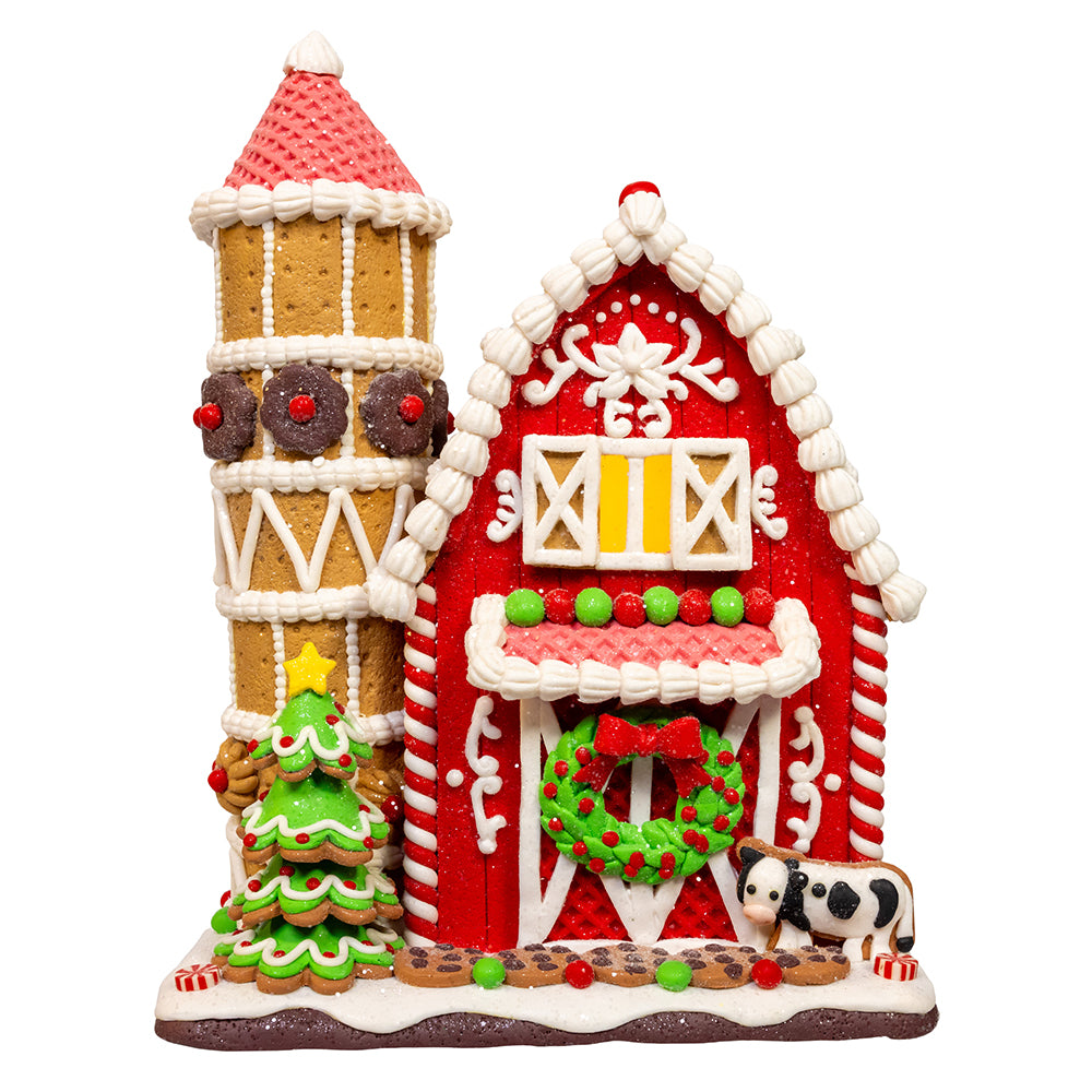 Decorative gingerbread house with a tower and barn design on a white background